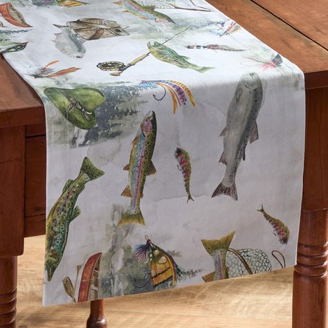 Reel in a new look to transform your dining experience into a relaxing lakeside retreat with our fishing-themed table runner. The intricate details of fish, fishing rods, lures, and other fishing gear designs that bring the joy of angling to your dining room space. Made of premium cotton material for a protective barrier to a tabletop surface from potential spills and messes created during meals. Functional and aesthetic appeal to elevate a dinner arrangement to showcase beautiful tableware incl Dinner Arrangement, Fishing Table, Western Pillows, Rustic Quilts, Rustic Napkins, Fishing Party, Dining Room Spaces, Kids Fishing, Fishing Birthday