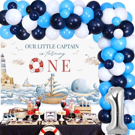 PRICES MAY VARY. Nautical Party Decorations for 1st Birthday: Include 1pc our little captain is turning one backdrop 5*3 ft, 54pcs latex balloons 12”, 15pcs latex balloons 5”, 1pc number 1 foil balloon 32”, 1pc balloon tape strip, 1 roll of adhesive dots and 2pcs ribbons. High Quality: Nautical first birthday party decorations are made of premium latex, foil and vinyl, sturdy and durable. Unique Design: Our little captain is turning one backdrop is designed as cute nautical themed patterns, matc Nautical First Birthday Party, Pirate 1st Birthday Party, Sailing Into One Birthday, Nautical Birthday Decorations, Nautical First Birthday, Beach Theme Birthday, Sailor Birthday, First Birthday Theme, Ocean Sailing