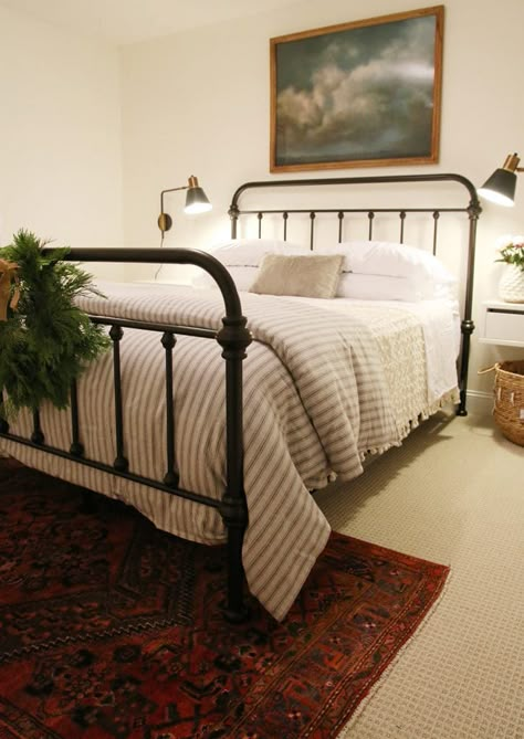 A Guest Room Update + Our Favorite Things to Include - Chris Loves Julia Simple Made Bed, Farmhouse Striped Bedding, How To Make A Guest Bed, Striped Duvet Bedroom, Iron Bed Frame Bedroom Decor, Striped Comforter Bedroom, Black Iron Bed Decor, Iron Bed Bedroom, Metal King Bed