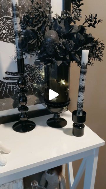 Janelle McGhee -DIY and Decor on Instagram: "If you need a vase, you should check out a thrift store. This vase was only $1.99. I wanted to make this vase work with my Halloween decor and a little black spray paint always helps. I used star stickers to create a little interest on the vase before spraying it. I knew I wanted to add some lights to the vase and the stars allow the light to come through without seeing the battery box and wire. I will find any excuse to add velvet ribbon to anything and everything, so I did just that. With some Halloween florals, it's the perfect little goth glam accent in my decor. It adds a little warm glow each evening. 
🖤
🖤
#halloweenideas #halloweendecor #halloweendecorating #gothichomedecor #thriftedhomedecor #gothhomedecor #gothglam #diyhalloweendecor Paint Glass Vase, Halloween Florals, Painted Glass Vases, Thrifted Home Decor, Goth Glam, Black Spray Paint, Goth Home Decor, Gothic Home Decor, Star Stickers