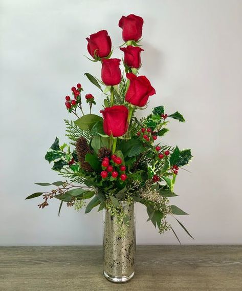 If you can't go home for the holidays, send your love with the Christmas Rose arrangement! Half a dozen long stem red roses with seasonal greenery in our beautiful keepsake mercury glass container. #GeorgesFlowers Dozen Roses Arrangement, Floral Arrangements Winter, Valentine Arrangements, Holiday Flowers, Rosé Christmas, Fresh Flower Arrangements, Dozen Roses, Hosting Holidays, Roanoke Va