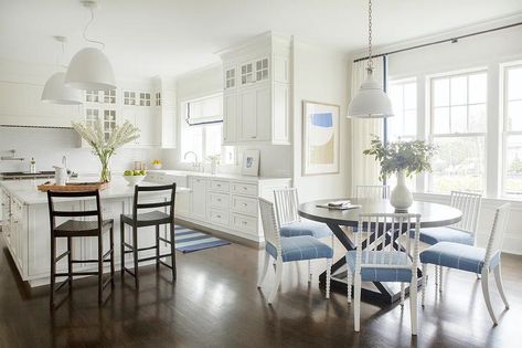 Brown wooden stools sit at a white square kitchen island lit by two modern white industrial lanterns. Sarah Bartholomew Designs, Chinoiserie Dining Chairs, Built In Dining Bench, White Oval Dining Table, Sarah Bartholomew, Hamptons Style Interior, Blue And White Kitchen, Bamboo Dining Chairs, French Dining Tables