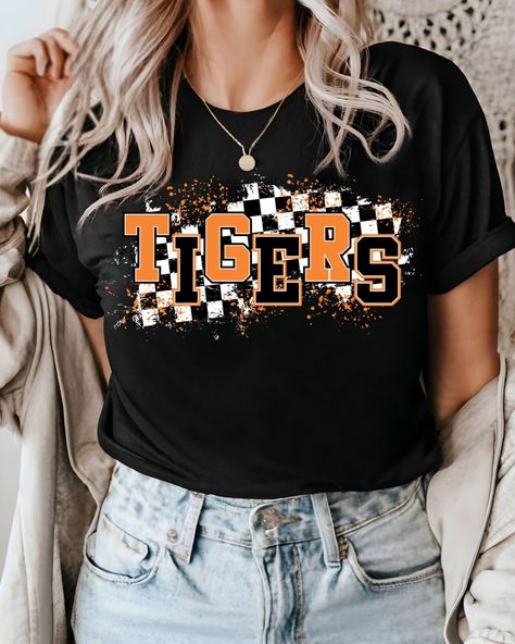 Looking for a way to show off your love for the Tigers? Made with high-quality direct-to-film transfer, this full-color transfer is perfect for showing off your school spirit at games, tailgates, or just around town. With its bold and vibrant design, this transfer will stand out on any color t-shirt you choose to apply it on. And because it can be applied to cotton, poly-cotton blends, un-coated polyesters, and 50/50 blends, you'll have plenty of options to choose from. This Tigers DTF Transfer Tiger Tshirt Ideas, Cheer Apparel, School Spirit Shirts Designs, Tigers Shirt, Mascot Shirt, School Spirit Shirts, Tiger Shirt, Football Mom Shirts, Sport Shirts