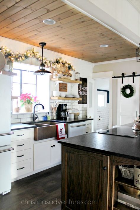 Farmhouse Christmas Kitchen- so many things to love!  Barn door, subway tile, wood ceiling, open shelving, shiplap, copper sink and so much more! Farmhouse Christmas Kitchen, Kitchen Sink Decor, Fixer Upper Kitchen, Fixer Upper Home, Coastal Kitchen Design, Tile Wood, Comfortable Kitchen, Christmas Farmhouse, Barn Light