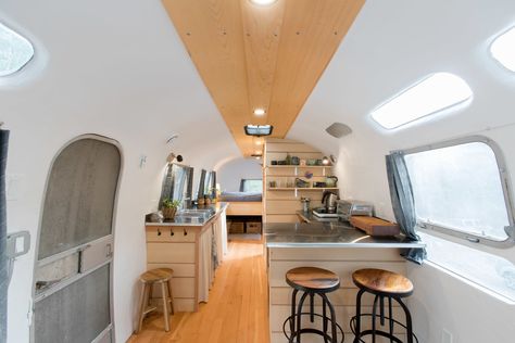 A Canadian Couple Revitalize a 1970s Airstream Using Salvaged Materials - Dwell Airstream Bedroom, Rv Interiors, Airstream Travel Trailers, Curtains Diy, Built In Sofa, Airstream Remodel, Airstream Interior, Airstream Renovation, Light Hardwood