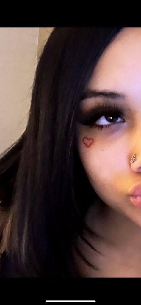 Heart On Cheek Tattoo, Heart Cheek Tattoo, Heart Dermal Piercing, Cheek Tattoo For Women, Heart Under Eye Tattoo, Face Heart Tattoo, Chin Tattoo Woman, Cool Piercings Face, Heart Eye Tattoo