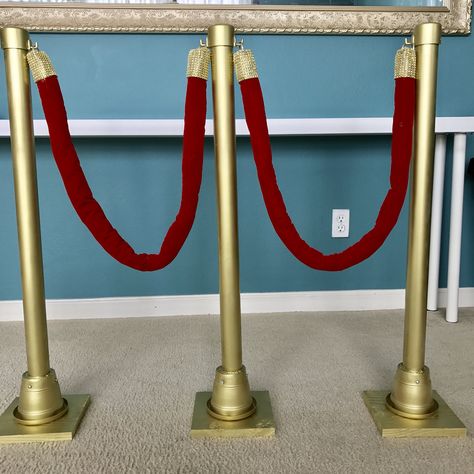 DIY Hollywood stanchion  So my Niece’s 18th birthday was Hollywood glam...sooo I decided to make her these my own version stanchion 😂   Items I bought were pvc pipe, pvc cap, plank wood cut in 6 pieces, a 6 small plant pot, a velvet cloth to make the rope, 6 bags of cotton balls for the rope filler, rhinestone ribbons, hooks, hooks and gold spray paint. Diy Stanchions Ideas, Diy Red Velvet Rope, Velvet Rope Diy, Diy Red Carpet Rope Stand, Deco Cinema, Hollywood Birthday Parties, Oscars Party Ideas, Hollywood Birthday, Movie Night Birthday Party