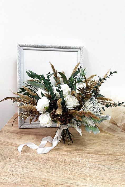 That seasonal bouquet could be elegant for your big day. In my opinion, that enhances any winter ceremony. Collect this inspiration to your winter wedding inspiration. Pine Wedding Bouquet, Pampas Wedding Bouquet, Bridal Bouquet Greenery, Wedding Bouquet Pampas, Bridal Bouquet Winter, Wedding Bouquet Winter, Greenery Bridal Bouquet, Wedding Flowers Boho, Bouquet Greenery