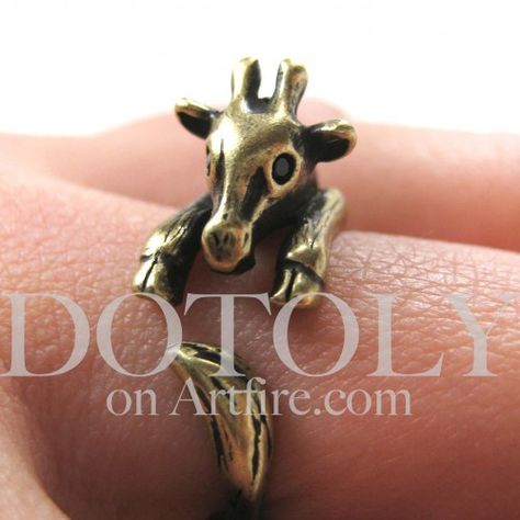 - Description - Sizing This is one of our most popular animal wrap rings! It is made in the shape of a baby giraffe that wraps around your finger in brass. Available in sizes 4 to 9, half sizes are al Animal Wrap Rings, Giraffe Ring, Wrap Around Ring, Animal Themed Jewelry, A Giraffe, Animal Rings, Detailed Ring, Baby Giraffe, Themed Jewelry