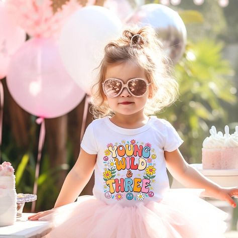 🌸 Celebrate your little one's big day with our "Groovy Threes" Tee! 🌼 This adorable and retro-inspired shirt is perfect for girls celebrating their 3rd birthday. Featuring vibrant pastels, whimsical flower motifs, and a playful font, this tee embodies the fun and groovy spirit of a bygone era. Ideal for photoshoots and birthday parties, ensureing your young wild and three shine on their special day. 🎉 #YoungWildAndThree  #RetroBirthday #FlowerChild #GroovyBirthday #HippieBirthday Retro 3rd Birthday, 3rd Birthday Shirt, Young Wild And Three, Three Girls, Birthday Tshirts, Birthday Tee, Third Birthday, 3rd Birthday Parties, Princess Birthday