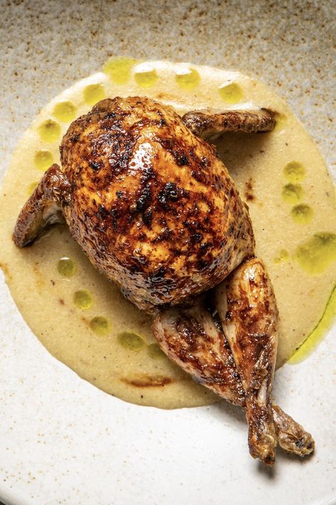 This beautiful quail dish from Joké Bakare is served with a creamy nsala sauce and fresh uziza herb oil. The recipe uses many of the traditional seasonings of ofe nsala (nsala soup, or white soup) - uziza leaves, prekese and aidan fruit - and each one is celebrated in Joké's own distinctive style. The quail requires deboning and brining overnight, so be sure to start the night before you want to eat. Cornish Hen Plating, Fine Dining Southern Food, Quail Egg Appetizer, Fine Dining Chicken Recipes, Herb Oil Recipe, Ancho Chili Sauce, Gordon Ramsay Dishes, Dnd Food, Quail Recipes