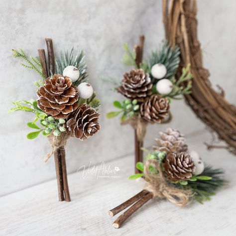 "Winter wedding boutonniere designed for winter lovers and mountain weddings, making it a perfect fit for your woodland wedding celebration. A pretty alternative to the wedding flowers for the groom and ideal wedding accessories for the father of the bride, father of the groom, groomsmen, and all the important men on your Big Day. Each piece features artificial cedar and pine tree greenery, frosted berries, small natural pine cones and wooden sticks, all wrapped in twine, providing a rustic feel Winter Wedding Plate Setting, Pine Wedding Bouquet, Winter Wedding Snacks, Pine Cone Wedding Decorations, Winter Wedding Bouquet Evergreen, Small Winter Wedding Ideas, Mountain Wedding Bouquet, Yule Wedding, Winter Wedding Boutonniere