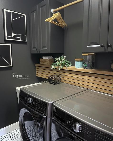 Incredible transformation in just two days! The decision to paint the walls ‘Iron Ore’ from @sherwinwilliams was spot on—it adds a dramatic and modern vibe. The sleek wood slat panel is a perfect way to hide the washer and dryer hookups, and it complements the bold geometric flooring perfectly. This laundry room makeover is seriously one of my favorites. #LaundryRoomMakeover #HomeTransformation #IronOre #SherwinWilliams #ModernDesign #DIYHome #InteriorInspo #LaundryRoomGoals #furnitureartis... Laundry Room Black Accent Wall, Laundry Room With Black Countertop, Iron Ore Laundry Room, Hiding Laundry Room Hookups, Moody Laundry Room, Black Laundry Room, Grey Laundry Rooms, Small Laundry Room Makeover, Dark Grey Paint