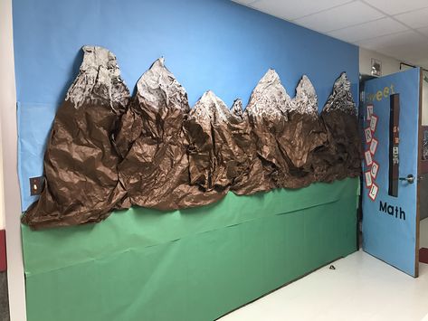 Mountains bulletin board - brown paper and white paint Paper Pine Trees Classroom, Mountain Climbing Classroom Theme, Construction Paper Mountains, How To Make A Mountain Out Of Paper, Together We Can Move Mountains Bulletin Board, Mountain Party Decorations, Mountain Display Classroom, Mountain Hallway Decor School, Cardboard Mountains Backdrop