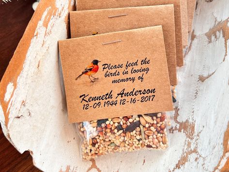 "24 Birdseed funeral favors per set.  At checkout, you can choose additional quantities. Introducing our heartfelt Baltimore Oriole funeral bird seed packets, a meaningful way to honor your loved ones by feeding the birds. Inside each carefully crafted package lies not just bird seed, but a seed of love, kindness, and cherished memories. As you scatter these seeds, you are sowing the same love that your loved one showered upon you, ensuring that their spirit continues to touch the world.  choose Bird Seed Gifts, Memorial Gift Diy, Bird Seed Favors, Diy Seed Packets, Memory Items, Feed The Birds, Baltimore Oriole, Remembering Mom, Hospice Care