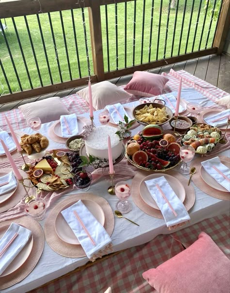 pink aesthetic picnic with cake, sushi, croissants, chips and salsa, charcuterie board, snacks, strawberry jam, fruit platter, and decorations like candles and flowers. Picnic Birthday Party Adult Pink, Bridal Shower Ideas Picnic, Fancy Picnic Ideas, Bridal Shower Picnic Theme, Pink Beach Birthday, Picnic Bridal Shower Ideas, Pink Picnic Aesthetic, Ideas De Picnic, Pink Picnic Party