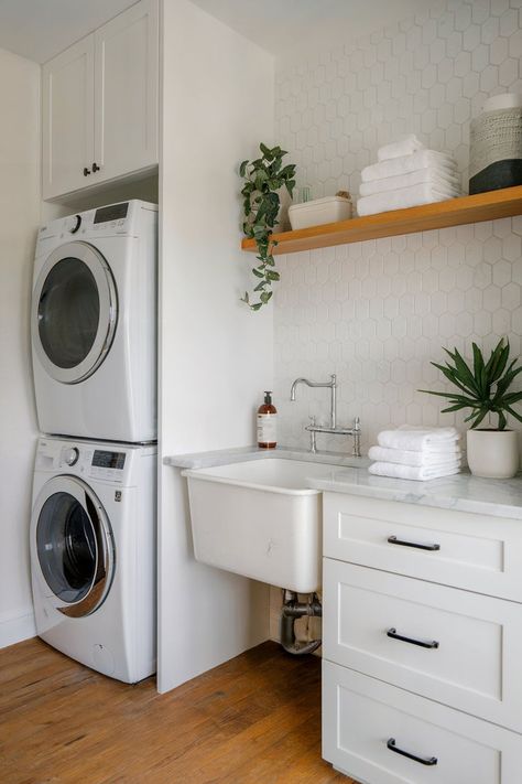 Laundry room with a functional slop sink, open shelving, and a stacked washer and dryer for practical use. Small Laundry Room Ideas With Toilet, Small Laundry Closet With Sink, Half Bath With Washer And Dryer, Small Laundry With Toilet, Laundry And Half Bath Combo, Slop Sink Ideas, Small Laundry With Sink, Small Laundry Room Ideas With Sink, Small Laundry Room With Sink