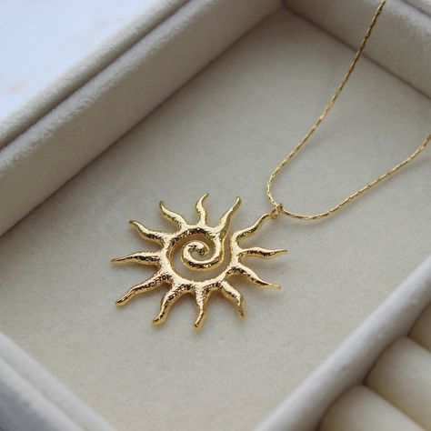 Sun Burst Necklace Length: 40cm Waterproof Stainless Steel Necklace 18K Gold Plating 5cm extender included Made with Stainless Steel and 18K Gold plating Packaging: All products come with freebies and are packed by hand, so they make a great gifting experience! Postage: All orders are dispatched in 1-2 working days. Materials and Care: This item is Stainless Steel and 18K gold plated. Regularly polish and buff the metal using a soft (lint-free) cloth. -------------------------------------------- Hand Jewelry Rings, Necklace Sun, Sun Burst, Pretty Jewelry Necklaces, Sun Necklace, Sun Pendant, Euro Summer, Dope Jewelry, Jewelry Lookbook