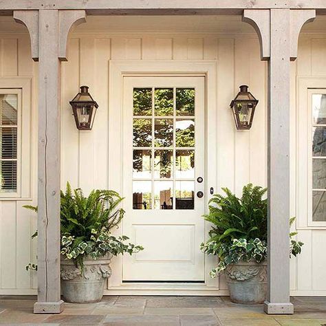 This wood-and-glass door nearly fades into the background as it's painted the same ivory hue as the rest of the house and could easily be mistaken for a window: http://www.bhg.com/home-improvement/door/exterior/farmhouse-front-door/?socsrc=bhgpin042114goingincognito&page=4 Farmhouse Porch Decor, Brick Houses, Farmhouse Exterior Design, Farmhouse Front Door, Casa Country, Pintura Exterior, Farmhouse Front Porches, Screen Porch, Farmhouse Porch