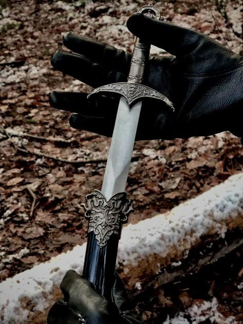 Aesthetically pleasing picture of a dagger being gently pulled from its sheath by a pair of black leather gloved hands. There is a snow covered log in the background. Pretty Dagger, Warlock Dnd, Gloves Aesthetic, Aesthetic Snow, Pretty Knives, Print Journal, Holly Black, Triple Goddess, Cool Knives