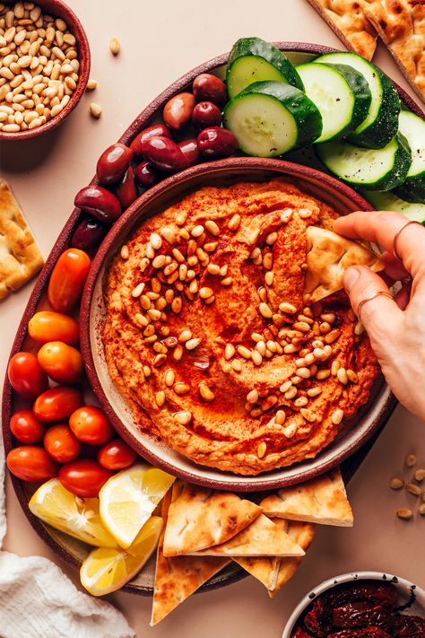 Dipping a slice of pita bread into a bowl of homemade sun-dried tomato hummus Sun Dried Tomato Hummus, Roasted Beet Hummus, Hummus Recipe Homemade, Healthy Indian Recipes, Beet Hummus, Wfpb Recipes, Relish Recipes, Vegan Dip, Pescatarian Recipes