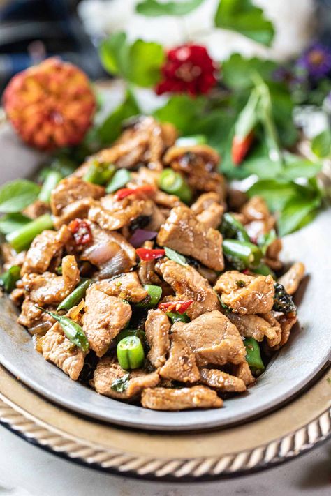 Whether you're a fan of Thai cuisine or new to its vibrant flavors, this Thai Basil Pork Stir Fry dish is easy to love. With the aromatic blend of holy basil, tender pork, and a mixture of Thai sauces, it's a delicious and quick meal that you can whip up in less than 20 minutes! #thaibasilpork #porkbasilstirfry #padkrapao #padkrapaomoo #Thaiporkbasil #thaibasilstirfry #padgrapao #thaistirfry Thai Basil Pork Stir Fry, Thai Sauces, Thai Basil Pork, Basil Pork, Fried Basil, Pineapple Pork, Thai Sauce, Pork Stir Fry, Stir Fry Dishes