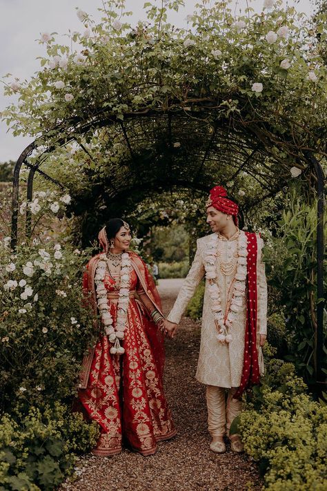 Bride in red and gold and groom also wearing red and gold tradiitonal wedding outfit for Sri Lankan and Indian wedding Bride And Groom Indian Wedding Outfit Red, Red Sherwani Indian Groom, Bride And Groom Indian Wedding Outfit, Wedding Decorations Red, Groom Indian Wedding Outfits, Luxurious Wedding Invitations, Braxted Park, Red Indian Wedding, Gold Sherwani