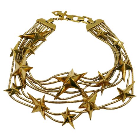 THIERRY MUGLER vintage gold tone multi strand snake chains choker necklace embellished with THIERRY MUGLER's iconic stars. Adjustable T-bar and toggle closure. Embossed THIERRY MUGLER and TM. Indicative measurements : adjustable length from approx. 32 cm (12.60 inches) to approx. 35 cm (13.78 inches). Material : Gold tone hardware. NOTES - This is a preloved vintage item, therefore it might have imperfections. - Colors may differ slightly from actual product appearance due to differences in lighting conditions. - As a buyer, you are fully responsible for customs duties, other local taxes and any administrative procedures related to imports into the country of destination. Avant Garde Jewelry, Vintage Choker Necklace, Vintage Choker, Thierry Mugler, Gold Choker, Chain Choker Necklace, Choker Necklaces, Chain Choker, Multi Strand