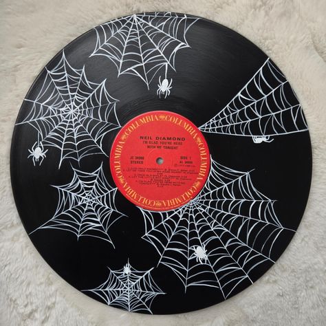 Spiderwebs are always more complex than I think they're going to be! What do you think of this one? ° ° ° #acrylicpainting #spookyart #spooky #record #vinylrecord #spiderweb #spider #uniqueart #art Vinyl Decoration Wall, Halloween Record Painting, Record Art Ideas, Spiderweb Painting, Vinyl Record Painting Ideas, Record Painting Ideas, Music Art Painting, Vinyl Record Painting, Vinyl Record Art Ideas