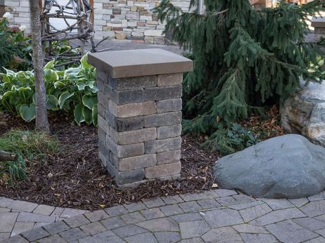 How to Install a Patio Landscape Block Pillar : Landscape block pillars add so much to your outdoor living space. They can help to define the space by giving it definition. The create dimension by being a vertical element in the landscape. With the addition of landscape lighting your usefulness of outdoor space can be extended into the evening. The great part about using concrete landscape retaining wall block to build a pillar is that it's not really all the difficult to add such a be… Diy Stone Columns, Landscape Retaining Wall, Paver Ideas, Brick Pillars, Landscaping Blocks, Retaining Wall Block, Brick Ideas, Outdoor Columns, Patio Paving