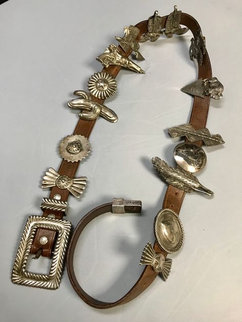 Arnold Goldstein Sterling Silver Concho Brown Belt Weight: 958 Grams, Lbs 2.1 Approximate Measurements: Belt Length: 47" Belt Width: 1" Charms from 2" to 3.5" Arnold Goldstein sterling silver concho brown belt 14 charms. Arnold Goldstein’s passion for Western and American Indian art began in his teens. At the age of 20, he was earning a living as a professional sculptor. Goldstein’s range as an artist, sculptor & designer is impressive. His western sculptures are reminiscent of Remington’s a Vintage Western Jewelry, Western Style Jewelry, Indian Inspired Jewelry, Belts Aesthetic, Western Inspiration, Western Sculpture, Western Womens Fashion, Indian Accessories, Work Belt