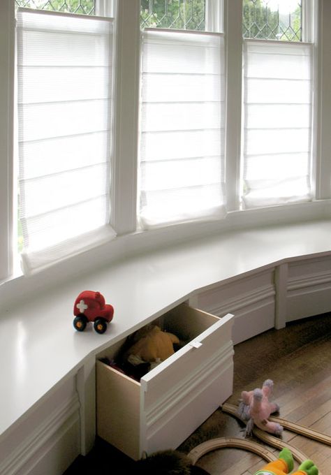 Playroom With Bay Window, Playroom Window Seat Storage, Bay Window Playroom, Playroom With Large Window, Playroom Bay Window, Curved Window Seat, Bay Window Toy Storage Ideas, Bay Window Toy Storage, Window Bench Seat With Storage Kids Room