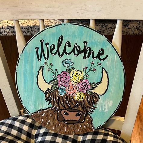 Highland cow with flower headress on a 12 inch round door hanger Highland Cow Door Hanger Wooden, Cow Door Hanger Wooden, Highland Cow Door Hanger, Cow Door Hanger, Circle Door, Farm Door, Hanger Ideas, Round Door Hanger, Circle Canvas