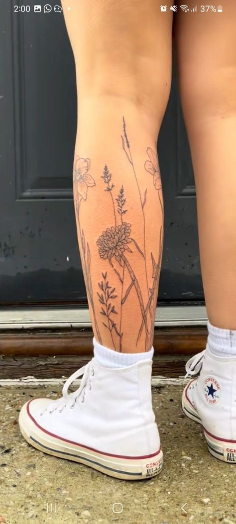 Flower Tattoo On Shin, Flower Leg Piece Tattoo, Flower Garden Tattoo Ankle, Wild Flower Calf Tattoo, Girly Thigh Tattoos Women, Flowers Calf Tattoo, Flower Wrap Leg Tattoo, Flower Around Ankle Tattoo, Flowers Around Leg Tattoo