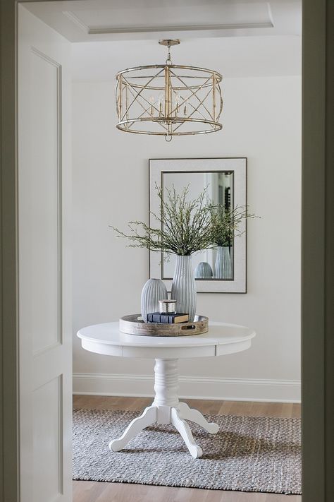 Open and Airy Townhouse Design - Home Bunch Interior Design Ideas Entrance Hall Round Table Decor, Round Entry Table Foyers, Styling Round Entry Table, Round Foyer Table Decor Entryway Traditional, Round Foyer Table Decor Entryway Modern, White Foyer Round Table, Semi Circle Foyer Table, White Round Table Decor, Round Entry Table Decor