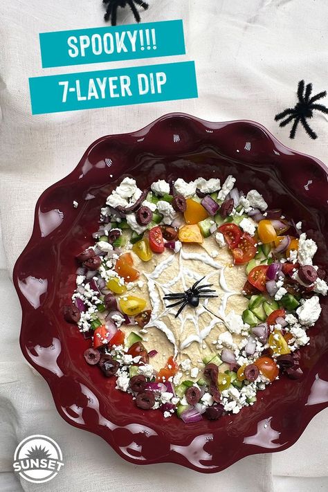 A Halloween appetizer inspired by Greek flavors! This Spooky 7-Layer Dip is a crowd pleaser for any gathering. Featuring creamy hummus, crisp One Sweet Cucumbers, juicy Wild Wonders Tomatoes, flavorful red onion, tangy kalamata olives and crumbled feta, this dish is topped with Greek yogurt and, of course a spider! Perfect for ghostly gatherings or as a festive, nutritious treat to balance out the candy overload! Sweet Cucumbers, Greek Layer Dip, Spooky Spider Web, Halloween Appetizer, Greek Dip, Creamy Hummus, Seven Layer Dip, Layer Dip, Greek Flavors