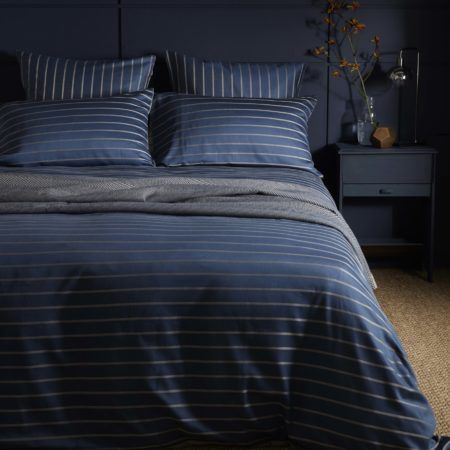 This is one of our favourite colour combinations, mixing dark blue and natural hues with our stylish Breton Stripe design.  Part of our luxury bedding, this blue striped duvet cover, is woven from 100% cotton (50% Egyptian cotton) with a 260 thread count. The super soft sateen finish feels smooth to the touch, making bedtimes even better. The design is fully reversible, so you can mix up how you want your bed to look as often as you fancy.  A perfect match for our Twill Midnight Blue bed linen. Popular Blue Paint Colors, Posh Pennies, Blue Bedroom Paint, Blue Bed Sheets, Blue Bedrooms, Blue Linen Bedding, Popular Paint Colors, Blue Duvet, Striped Duvet Covers