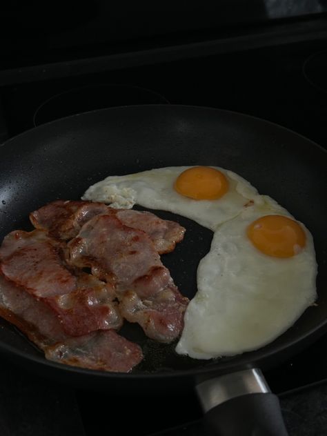 Dark theme picture of bacon and eggs in a black frying pan with low exposure Egg And Bacon Aesthetic, Breakfast Dark Aesthetic, Eggs And Bacon Breakfast Aesthetic, Breakfast Couple Aesthetic, Eggs And Bacon Aesthetic, Bacon Aesthetic, Breakfast Aesthetic Mornings, Gemini Character, Eggs Aesthetic