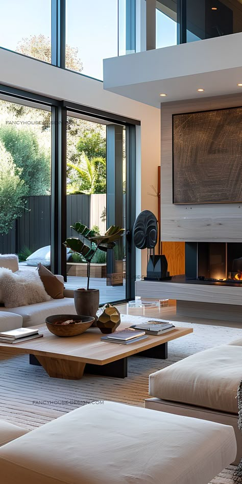 A contemporary living room boasts a double-sided modern fireplace design and warm lighting. Modern Fireplace Design, Airy Living Room, Modern Electric Fireplace, Textured Rug, Villa Interior, Open Living Room, Warm Lighting, Room Ambiance, Modern Fireplace