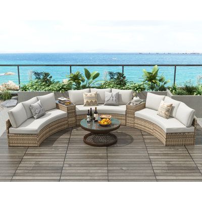 This 11-piece outdoor conversation set brings comfort and style to your patio or deck with its curved half-moon design. It includes a trio of 3-seat sofas and two wedge tables, offering versatile seating arrangements for up to nine people. This set features a spacious iron frame wrapped in breezy brown wicker, paired with beige water-and UV-resistant cushions that have removable covers for easy cleaning. The large tempered glass side table not only provides a spot for drinks and snacks but also Curved Patio Furniture, Patio Sets Outdoor, Semi Circle Sofa, Circle Sofa, Chic Cabin, Curved Patio, Outdoor Seating Set, Sofa Seating, Relaxing Outdoors