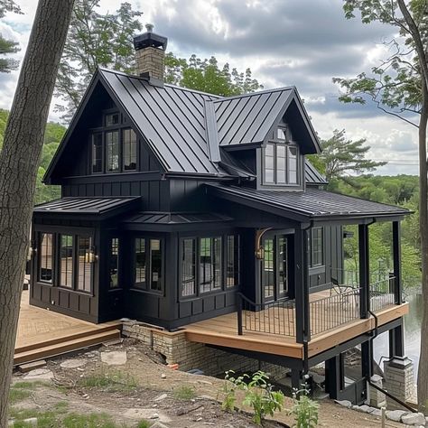 Image Dark Mountain Home Exterior, Black Houses With Wood Accents, Black Cabin Exterior, Dark Lake House, Black House With Wood Accents, Black Log Cabin Exterior, Black Lake House, Modern Log Cabins Exterior, Black Wooden House