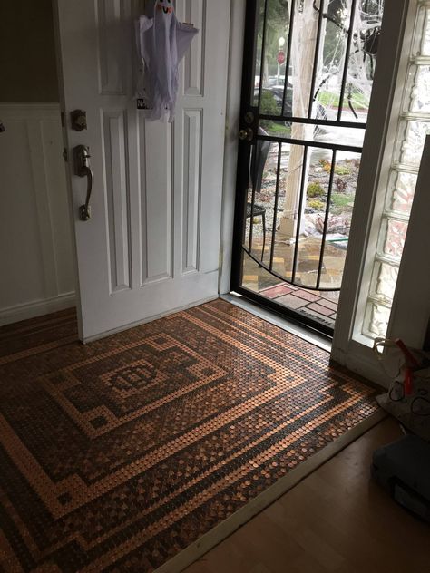 I made this copper penny floor in the foyer entrance way. It took me about a month to complete. I have a link to see more pics! Just click the photo! Penny Entryway, Penny Floors Diy, Custom Penny Tile Design, Copper Penny Floor, Copper Epoxy Floor, Penny Floors, Penny Floor Designs, Penny Mosaic, Inexpensive Flooring