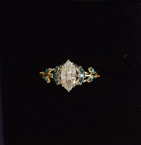 Marquise Engagement Ring With Emerald, Vine Engagement Rings, Marquise Gemstone Engagement Ring, Engagement Rings With Green Accents, Plant Inspired Engagement Rings, Engagement Rings Floral Leaves, Engagement Ring With Green Accents, Marquise Cut Engagement Ring Gold, Green Marquise Ring