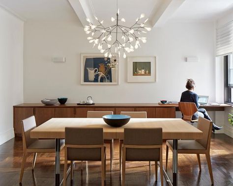 Modern dining rooms will find their perfect match in a sleek, wall-to-wall buffet table like this. Because the storage unit is so long, it doesn't need to be very wide, which allows the homeowners to enjoy more floor space. Notice, too, how architect James Wagman purposefully oriented the unit to sit parallel to the table; this technique helps showcase the clean lines of each piece and takes advantage of the most wall space. Ceiling Lights Uk, Dining Room Ceiling Lights, Dining Room Design Modern, Stylish Dining Room, Dining Room Ceiling, Dining Room Buffet, Dining Room Light Fixtures, Empty Nest, Dining Room Storage