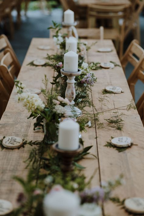 Pillar candlesticks, foliage runner, fern, place setting, wood slices Fern Table Decorations, Fern Wedding Table Runner, Fern Table Runner Wedding, Trestle Table Decor, Foliage Table Runner, Wedding Trestle Table Decorations, Ferns Wedding Decor, Fern Table Decor, Pillar Candles Decor