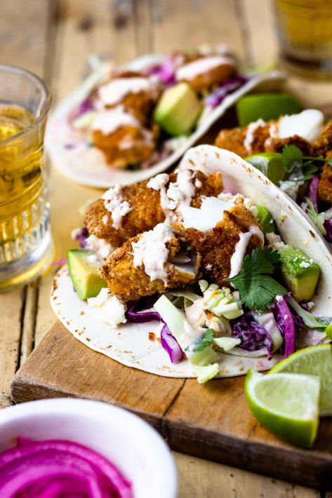 Crispy Baked Fish Tacos with Creamy Cilantro Lime Slaw - Modern Farmhouse Eats Spicy Fish Taco Sauce, Baked Fish Tacos, Tilapia Tacos, Spicy Fish Tacos, Pork Carnitas Tacos, Lime Slaw, Fish Taco Sauce, Grilled Fish Tacos, Quick Pickled Red Onions