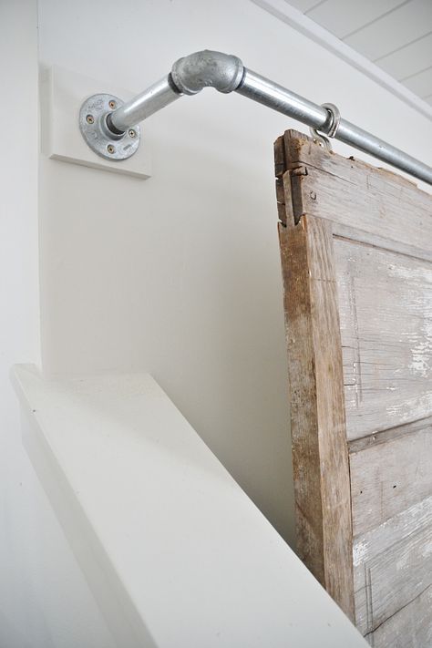 THE BEST WAY TO HIDE THOSE TV'S! A super simple industrial pipe sliding barn door television cover. A great way to decorate around those TV's in any room in your home.  See full tutorial on the blog. Tv Covers, Pipe Furniture, Industrial Pipe, Diy Barn Door, Interior Barn Doors, Diy Door, Barn Doors Sliding, Sliding Barn Door, Barn Door Hardware