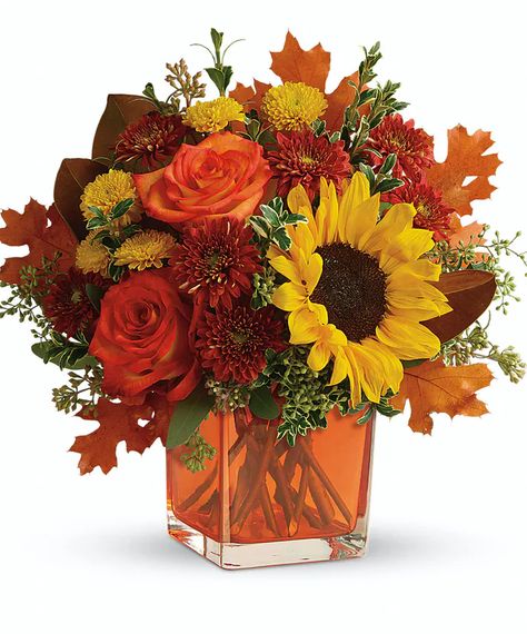 Sunny sunflowers and radiant roses in a happy orange cube vase bring joy to any fall décor! This bright bouquet includes orange roses, yellow sunflowers, gold cushion spray chrysanthemums, rust cushion spray chrysanthemums, seeded eucalyptus, oregonia, and magnolia leaves. #DurocherFlorist Thanksgiving Flowers, Orange Bouquets, Fall Flower Arrangements, Fall Floral Arrangements, Fall Arrangements, Autumn Flowers, Flowers For You, Same Day Flower Delivery, Orange Roses