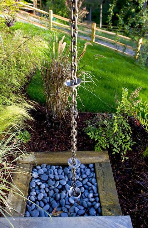 4 Top Creative Rain Chain Drainage Ideas Rain Chain Basin, Decorative Rain Barrels, Rain Chain Diy, Drainage Ideas, Gutter Drainage, Copper Rain Chains, Blue Rocks, Rain Collection, Contemporary Exterior