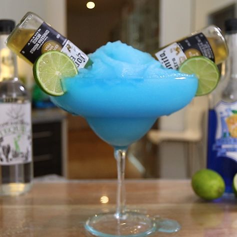 BLUE BULLDOG MARGARITA 8 oz. (240ml) Tequila 4 oz. (120ml) Blue Curaçao 4 oz. (120ml) Lime Juice 2 x Coronitas Garnish: Lime Wheels PREPARATION 1. Add ice, tequila, blue curacao and lime juice to blender. Combine until slushy. 2. Pour mix into large margarita glass. 3. Add two coronitas and garnish with lime wedge. DRINK RESPONSIBLY! Tipsy Bartender Drinks, Jungle Juice Recipe, Nursery Rhyme Quiz, Blue Bulldog, Bartender Drinks Recipes, Easy Alcoholic Drinks, Blue Drink, Flavored Margaritas, Flavored Beer